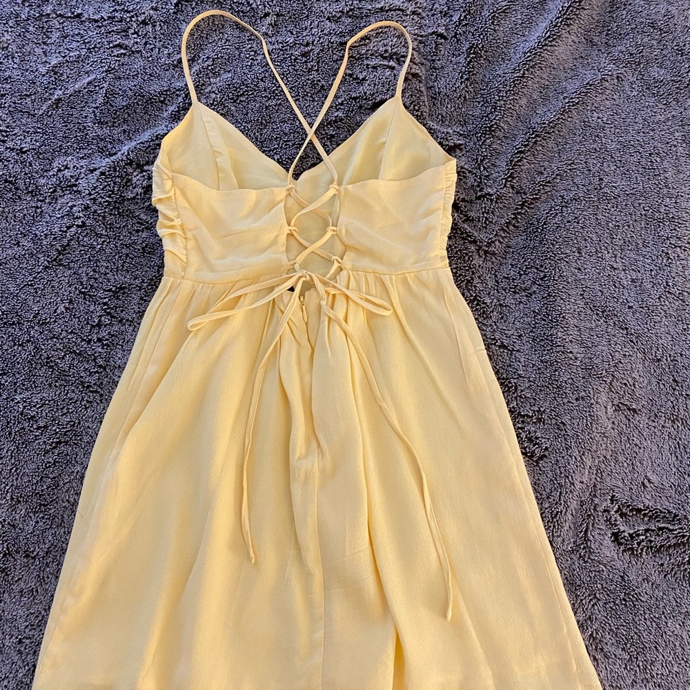 Yellow dress with tie detailing on the back